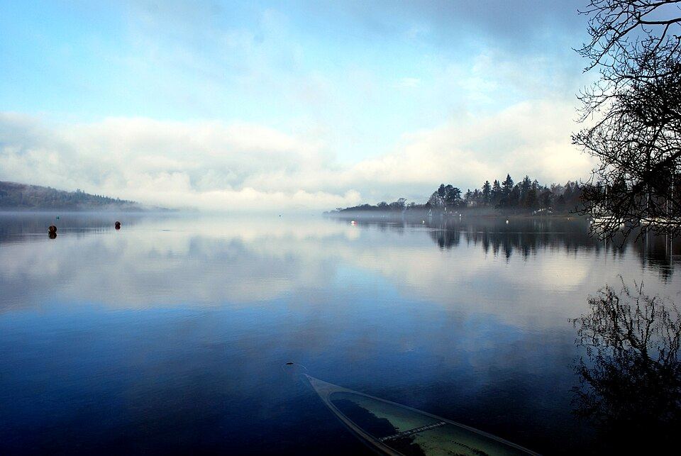 Misty morning on Lake Windermere with a canoe